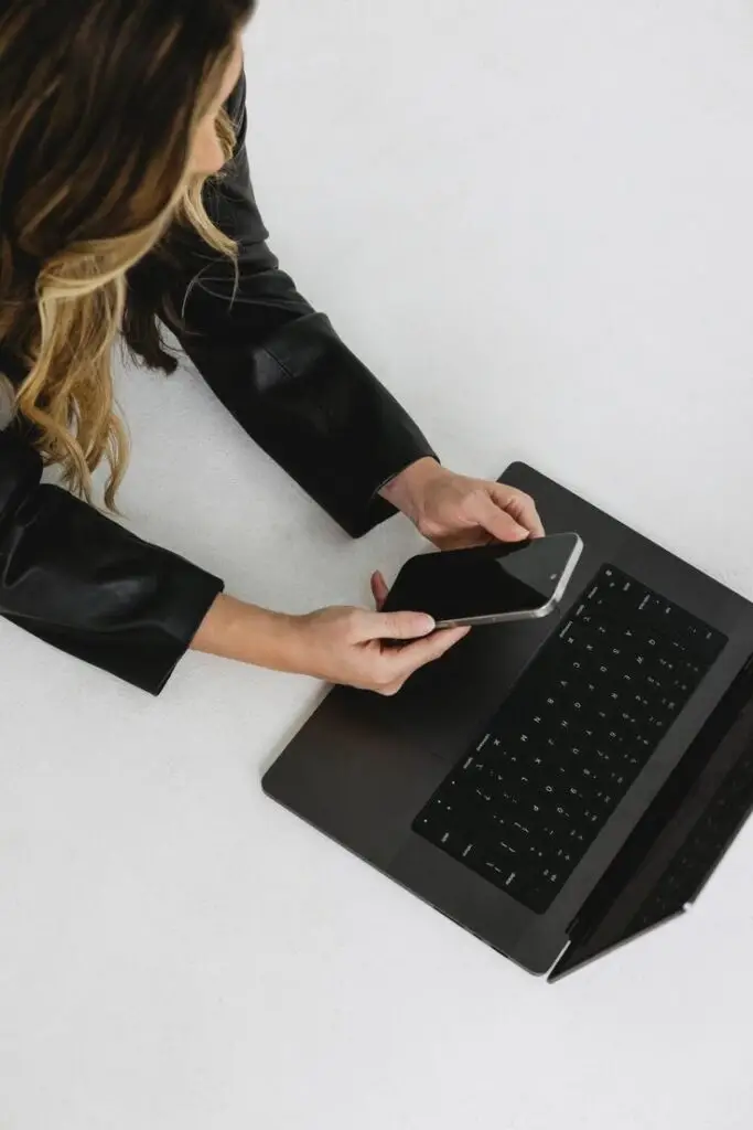Woman managing digital marketing strategy on laptop and smartphone, illustrating why PR takes time to work