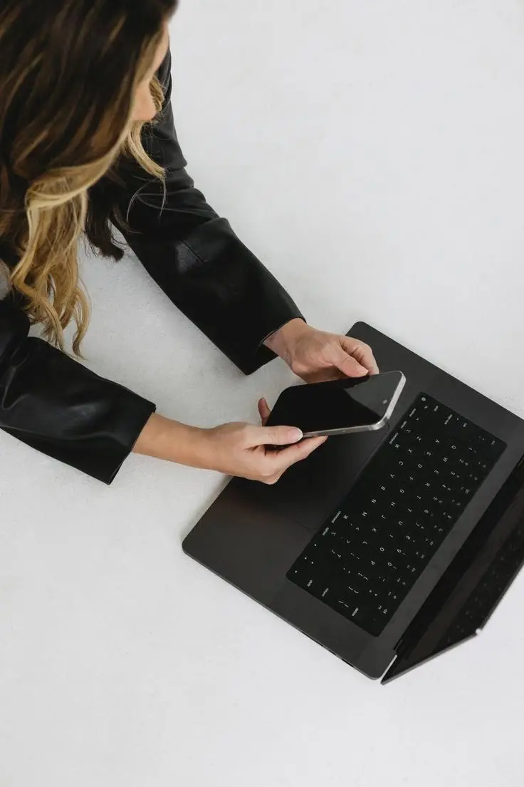Woman managing digital marketing strategy on laptop and smartphone, illustrating why PR takes time to work