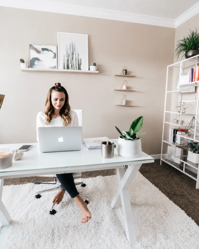 Woman working on laptop in a modern office showing how PR builds brand visibility and digital authority