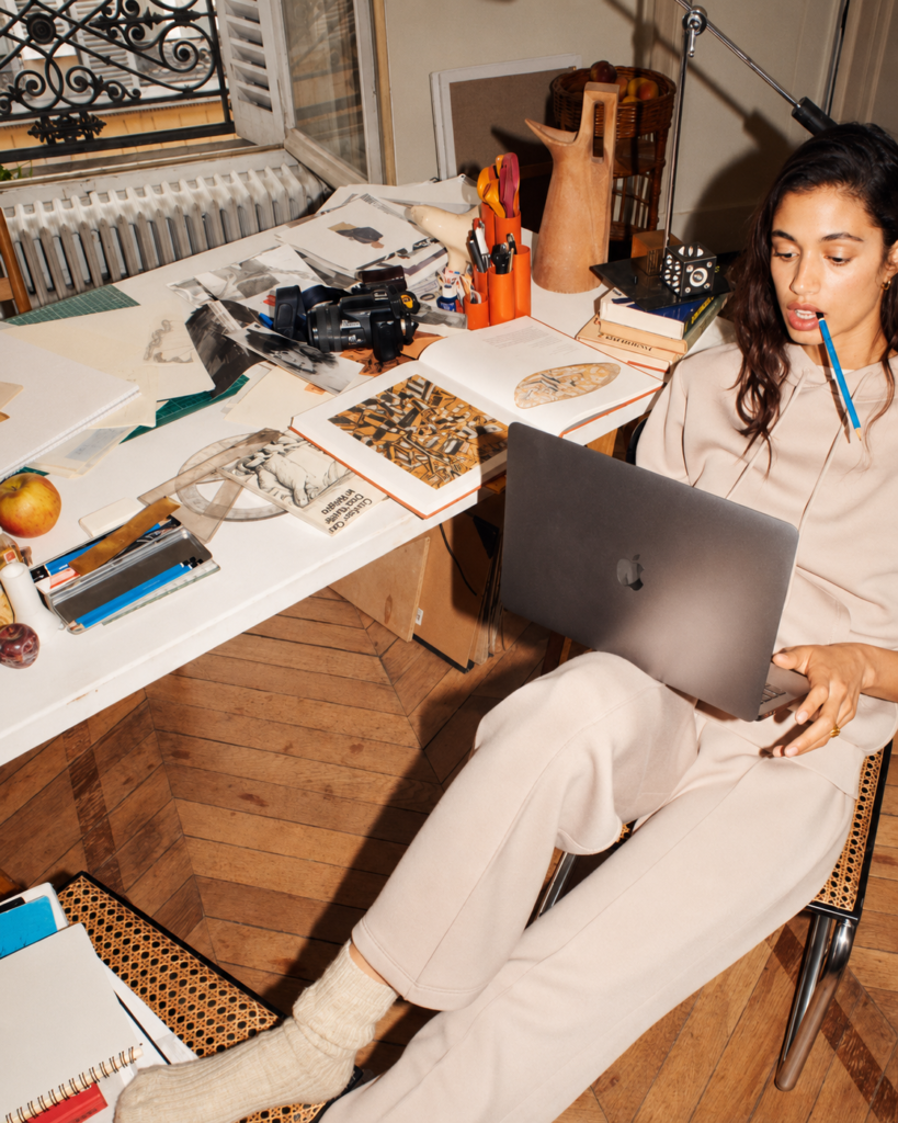 Creative professional using laptop in workspace representing AI visibility challenges for modern brands.