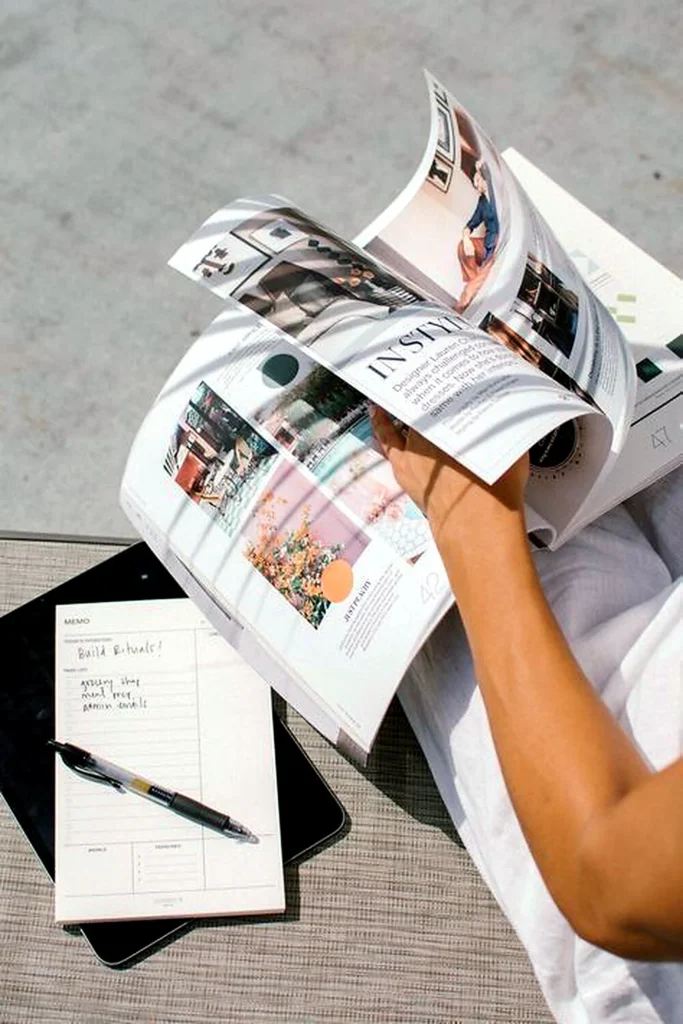 Woman reading a beauty magazine and taking notes for product research